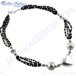 Load image into Gallery viewer, Silver beaded necklace with black beads and heart pendant on white background.