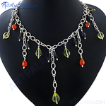 Load image into Gallery viewer, Silver chain necklace with teardrop-shaped orange and yellow gemstone accents displayed on a black bust