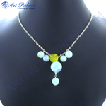 Load image into Gallery viewer, Silver chain necklace with light blue and yellow gemstones displayed on a mannequin