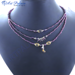 Load image into Gallery viewer, Layered necklace with garnet beads on a display mannequin. Features red gemstones and accents.