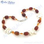 Load image into Gallery viewer, Red carnelian and freshwater pearl beaded necklace with a silver clasp, displayed on a white background