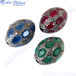Load image into Gallery viewer, Close-up of three gemstone beads: ruby, sapphire, and emerald set in silver. Luxury jewelry.