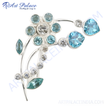Load image into Gallery viewer, Silver floral brooch with various blue gemstones on white background