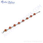 Load image into Gallery viewer, Sterling silver chain bracelet with flower design and vibrant orange gemstones.
