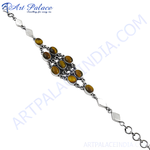 Load image into Gallery viewer, Sterling silver bracelet featuring oval tiger eye gemstones in a silver chain setting.