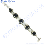 Load image into Gallery viewer, Sterling silver chain bracelet with various shaped black onyx stones, a toggle clasp, and a white background.