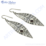 Load image into Gallery viewer, 925 sterling silver dangle earrings featuring a leaf design with a hammered texture and a round garnet gemstone center.