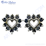 Load image into Gallery viewer, Sterling silver stud earrings with a heart-shaped design and dark blue sapphire gemstones.