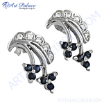 Load image into Gallery viewer, Silver stud earrings with blue sapphire gemstones in a floral design, perfect for women.