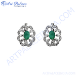 Load image into Gallery viewer, Sterling silver stud earrings featuring oval emeralds and sparkling diamonds in a floral design.