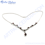Load image into Gallery viewer, 925 sterling silver necklace with a series of round garnet stones and a tear-drop shaped central garnet pendant.