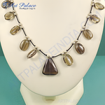 Load image into Gallery viewer, Smoky quartz pendant necklace featuring a triangular pendant and oval gemstones on a black cord.