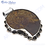Load image into Gallery viewer, 925 silver ammonite fossil pendant with intricate spiral design, set in a silver frame.