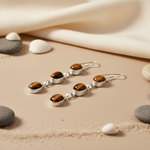 Load image into Gallery viewer, 925 sterling silver drop earrings with three oval-shaped tiger eye gemstones in a silver setting.