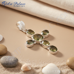 Load image into Gallery viewer, Sterling silver cross pendant with oval-cut green gemstones on white background.