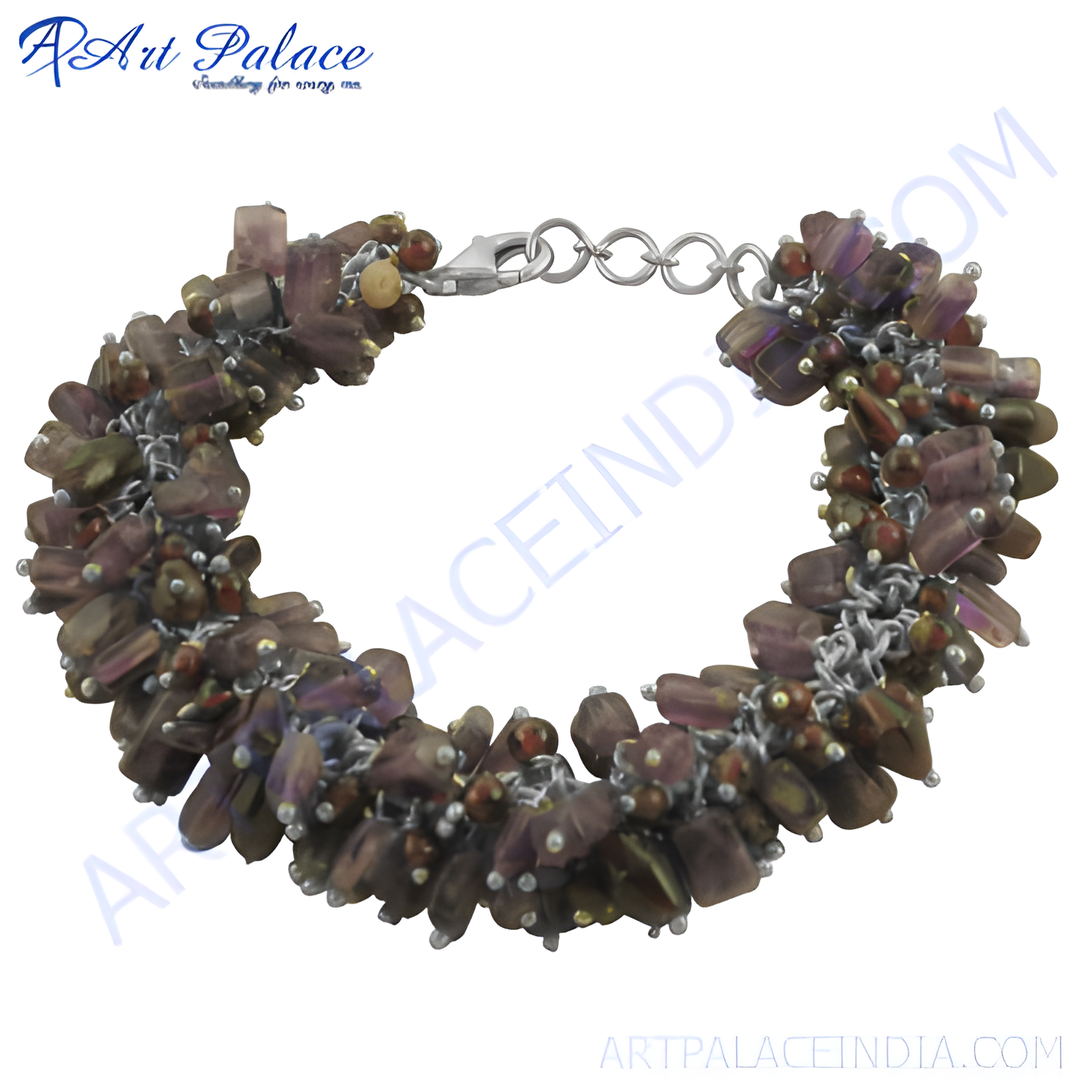 A close-up of a beaded gemstone bracelet with a silver clasp, featuring brown and purple beads.
