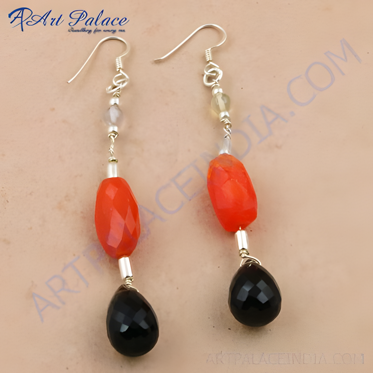 Silver dangle earrings featuring red and black gemstones, perfect for a stylish look