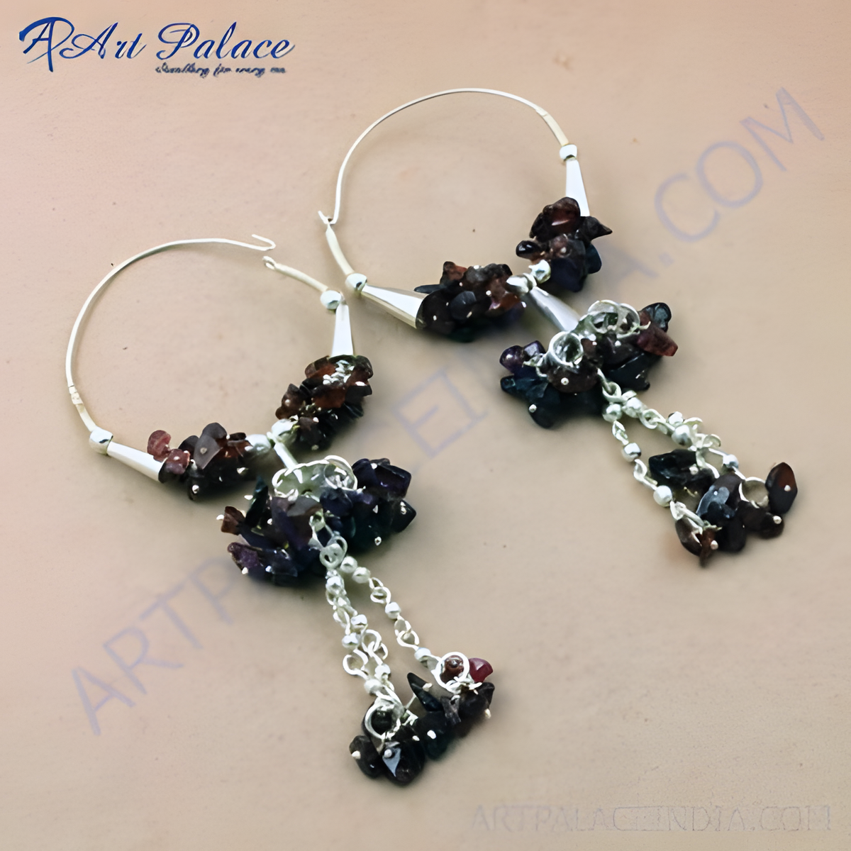 Sterling silver drop earrings featuring clusters of deep red and purple gemstones