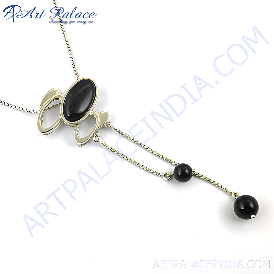 Silver pendant necklace with a large black onyx gemstone and dangling onyx beads.