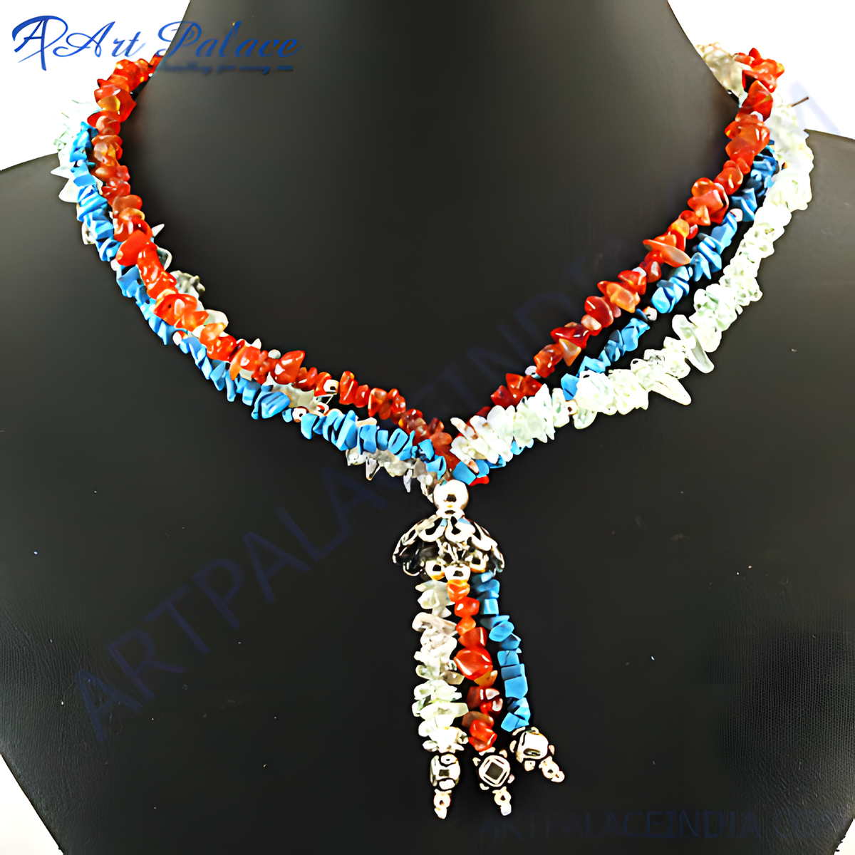 Multi stone beaded necklace with red, blue, and white gemstones on a black mannequin