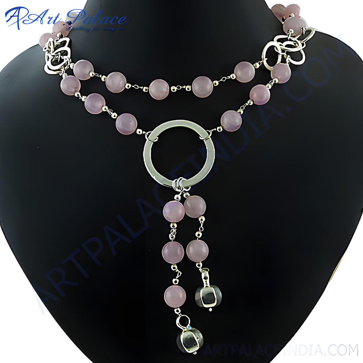 A silver necklace featuring pink rose quartz beads and a unique design
