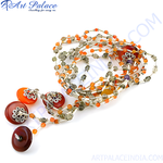Load image into Gallery viewer, A close-up shot of an intricate gemstone beaded necklace, featuring orange and gray beads.
