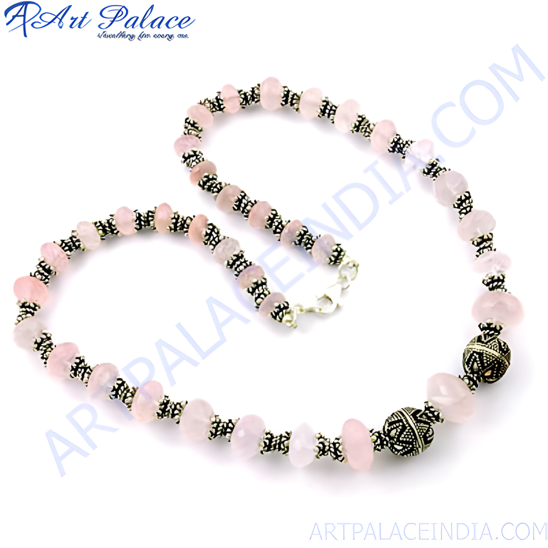 Rose quartz beaded necklace with sterling silver accents, featuring pink gemstone beads.