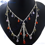 Load image into Gallery viewer, Silver cascade necklace with colorful gemstones displayed on a black mannequin.
