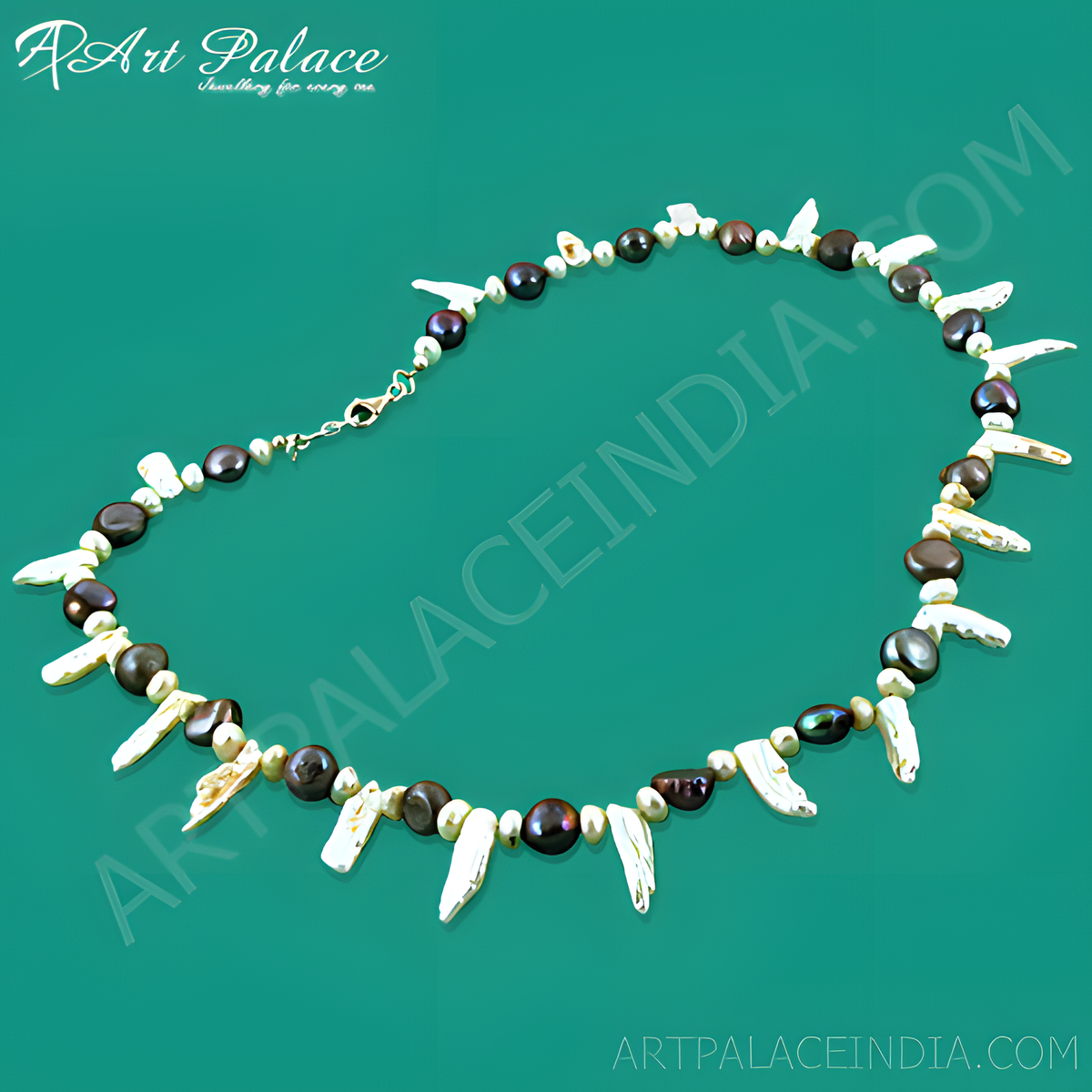 A unique pearl necklace featuring a variety of pearl shapes and colors, arranged on a green background