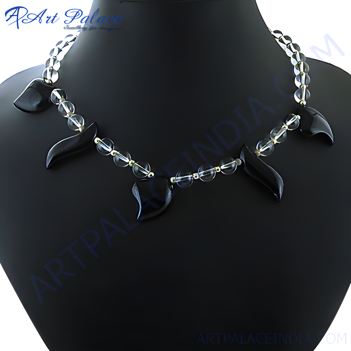 Black onyx and clear quartz statement necklace on a black jewelry display