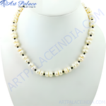 Load image into Gallery viewer, Elegant freshwater pearl necklace with black onyx bead accents on a white display.
