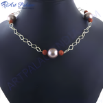 Load image into Gallery viewer, Pearl chain necklace with silver chain and brown beads on a black mannequin.
