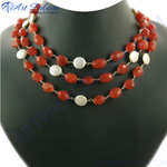 Load image into Gallery viewer, Three-strand red carnelian and mother of pearl bead necklace on a mannequin
