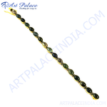 Load image into Gallery viewer, Gold chain bracelet with oval green tourmaline gemstones set in gold.

