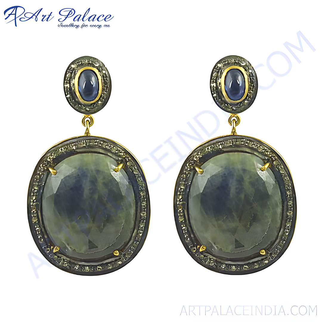 Sapphire and diamond drop earrings, featuring a large oval sapphire and smaller sapphire stud, set in a gold-plated frame.