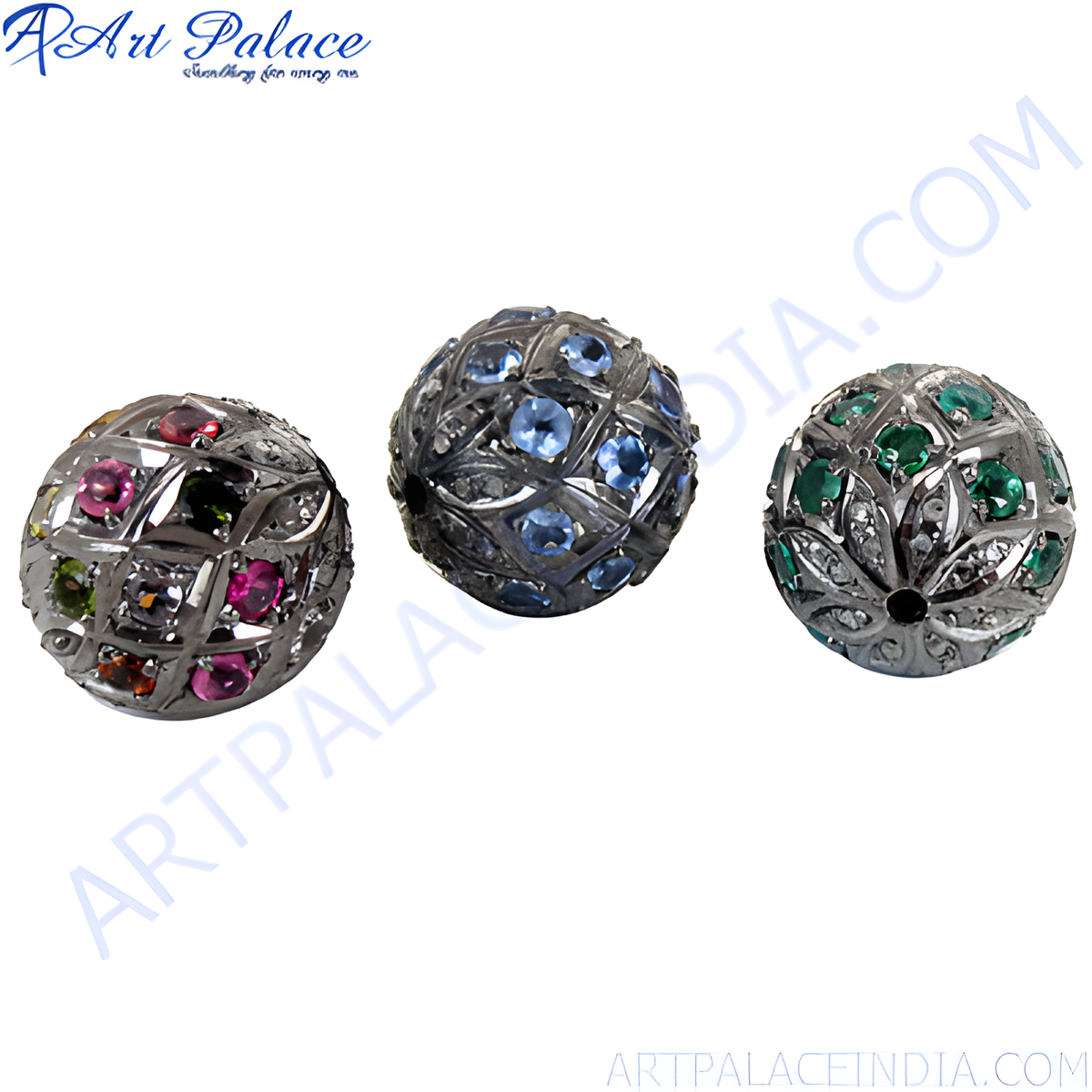 Close up of three sterling silver beaded ball beads with various colored gemstones embedded in a geometric pattern