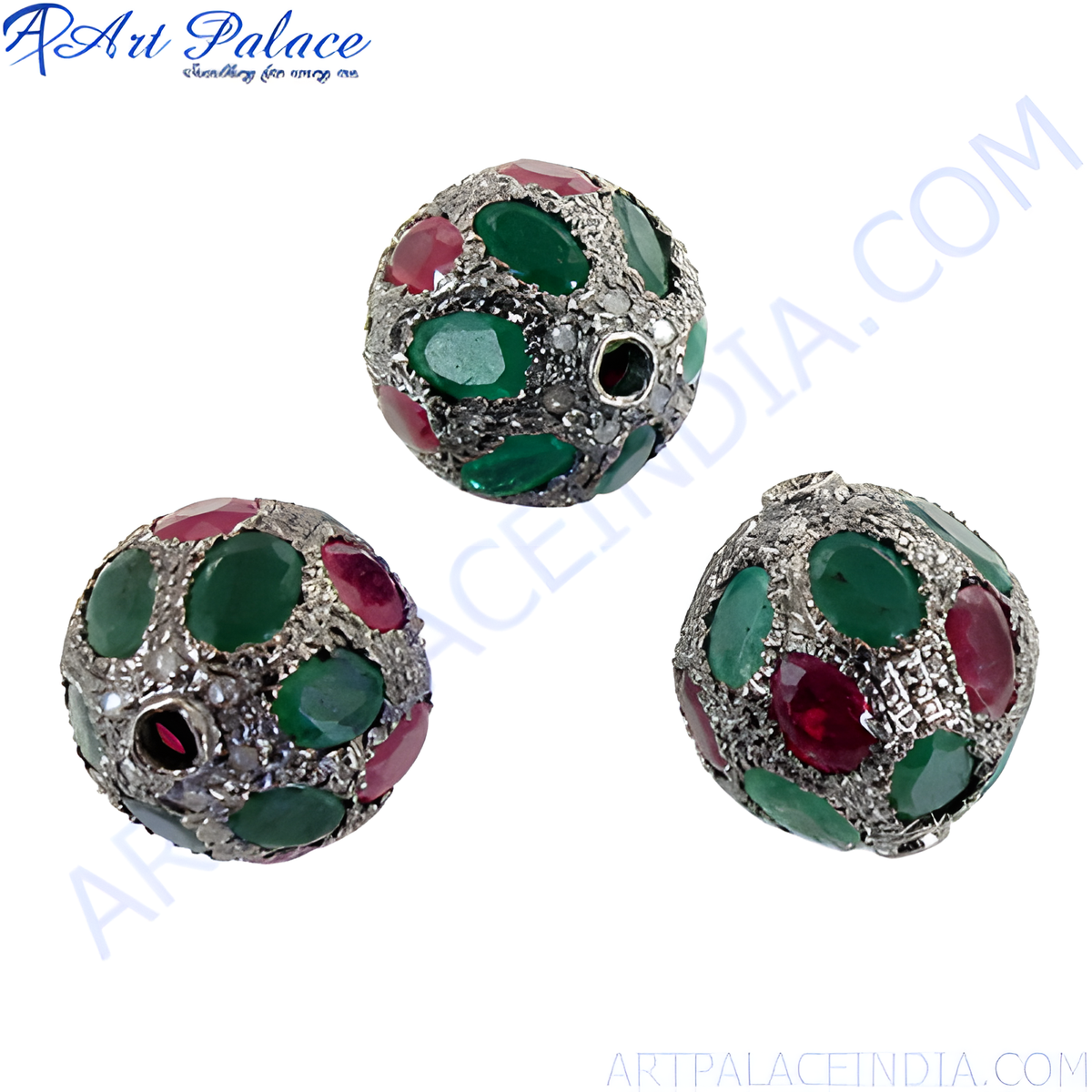 Close up of a silver pendant with round ruby and emerald gemstones, set in a beaded style