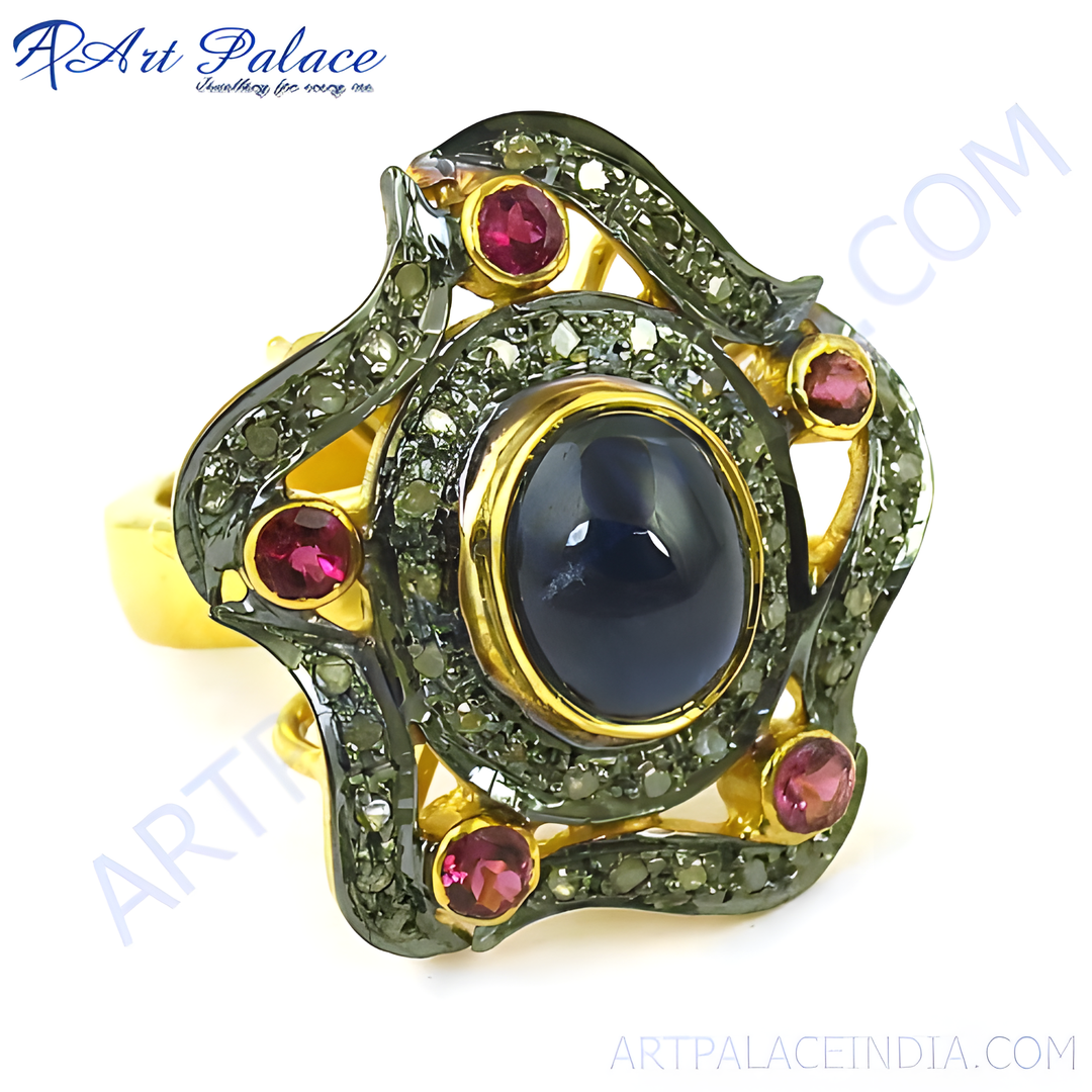 Gold plated cocktail ring with a large blue sapphire center stone and smaller ruby gemstones.