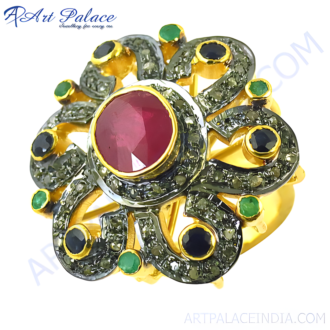 Gold plated cocktail ring with a central ruby and emerald accents in a flower design.