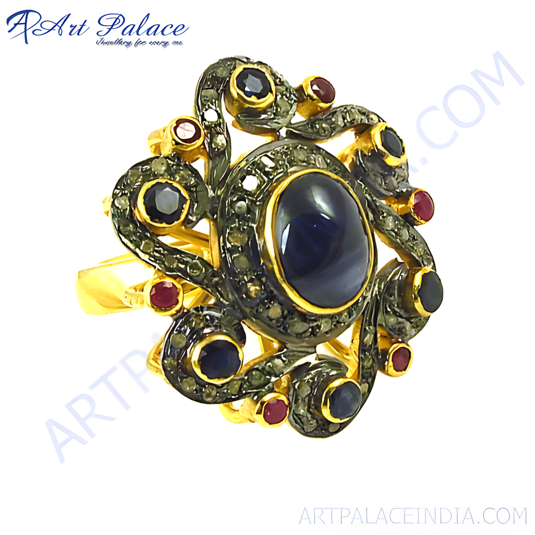 Oxidized gold ring featuring a large sapphire center stone and ruby accents in a floral design.