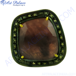 Load image into Gallery viewer, A close-up of a ruby gemstone ring with a dark red center stone and a halo of smaller gemstones on a white background
