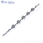 Load image into Gallery viewer, 925 sterling silver flower motif bracelet, linked chain design, white background.
