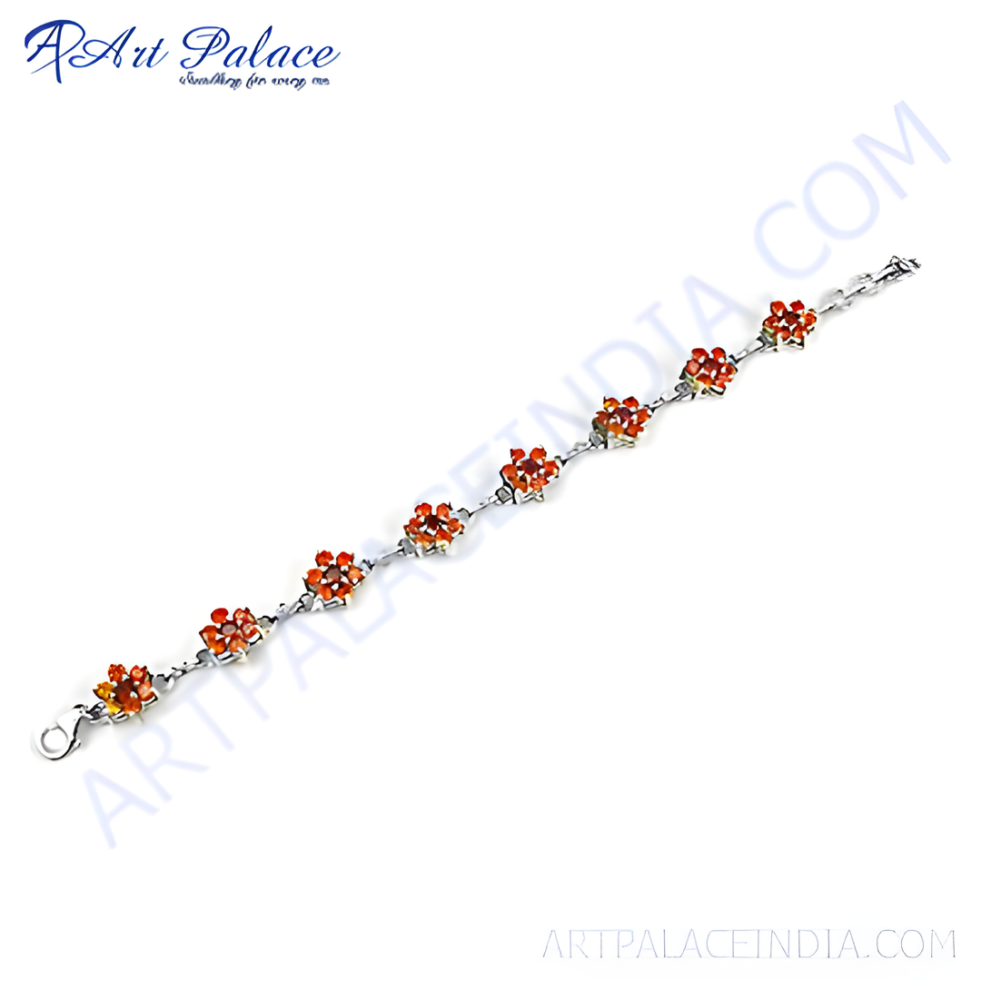 Sterling silver chain bracelet with flower design and vibrant orange gemstones.