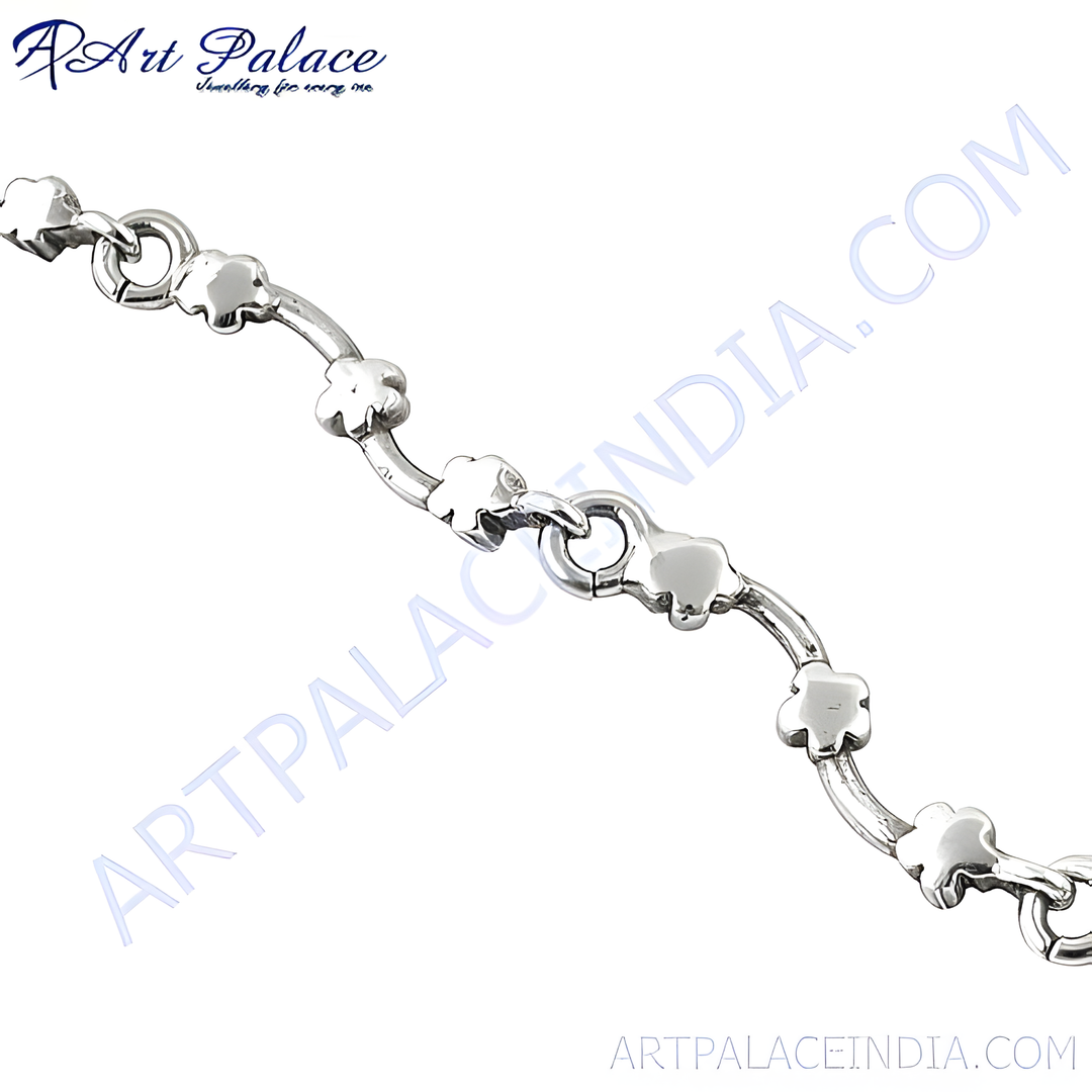 Sterling silver flower anklet on a white background, showcasing the intricate details of the jewelry.