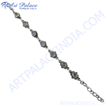 Load image into Gallery viewer, Sterling silver moonstone bracelet featuring oval-shaped gemstones linked by silver chain links.
