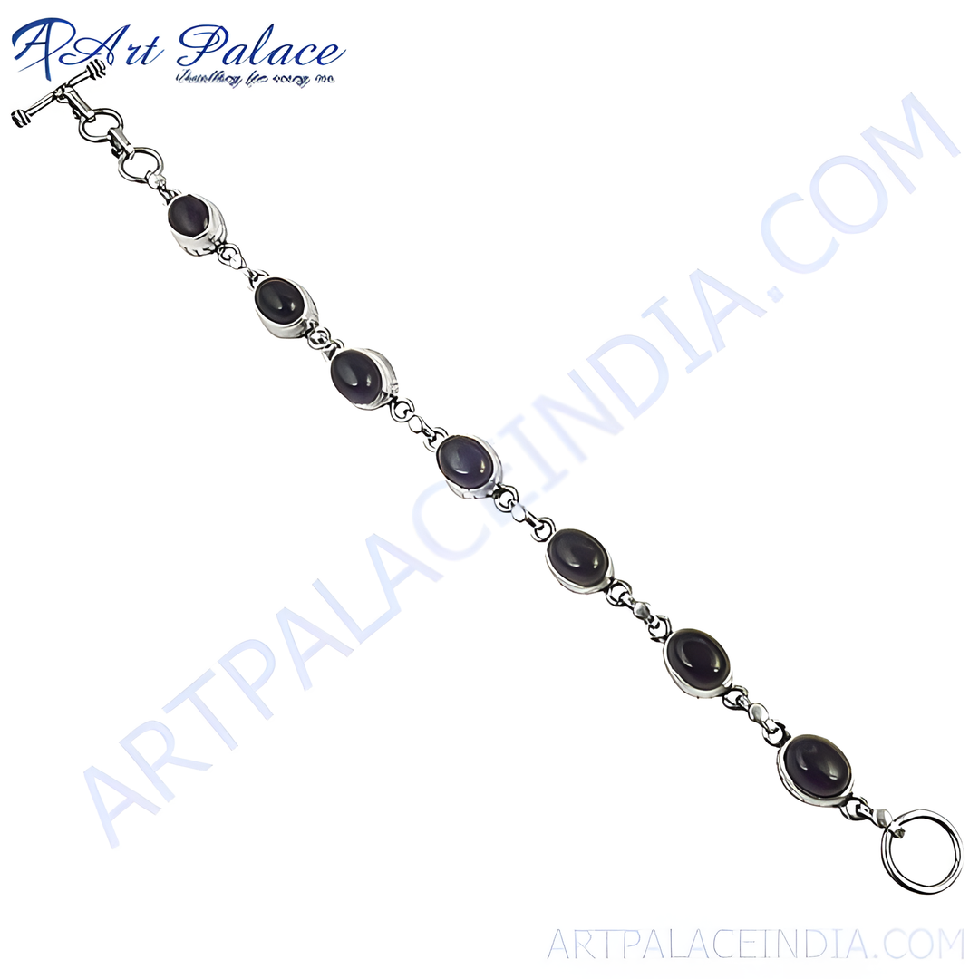 Sterling silver chain bracelet featuring oval black onyx gemstones, a perfect daily wear accessory.