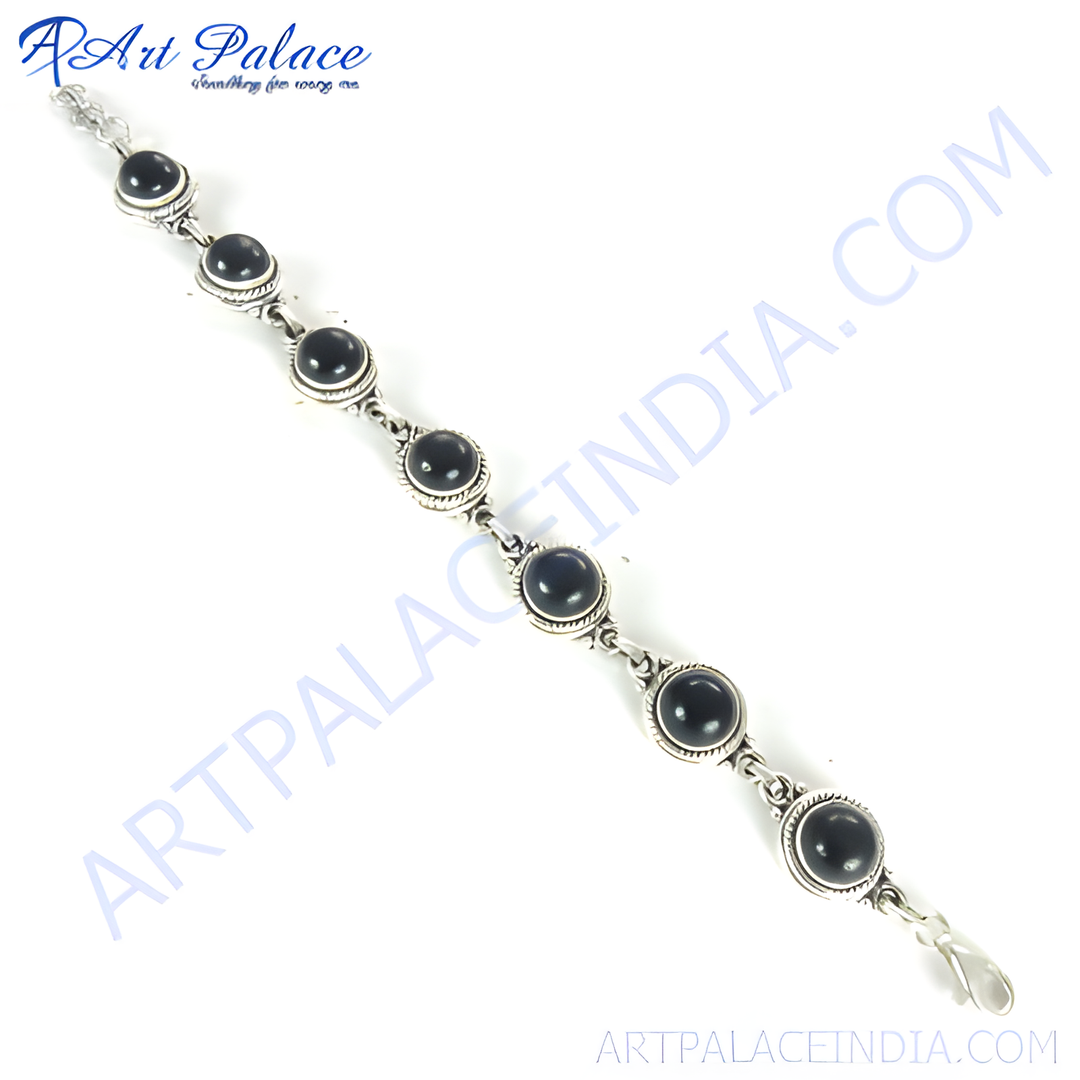 Sterling silver chain bracelet with round black onyx gemstones, perfect for any occasion.