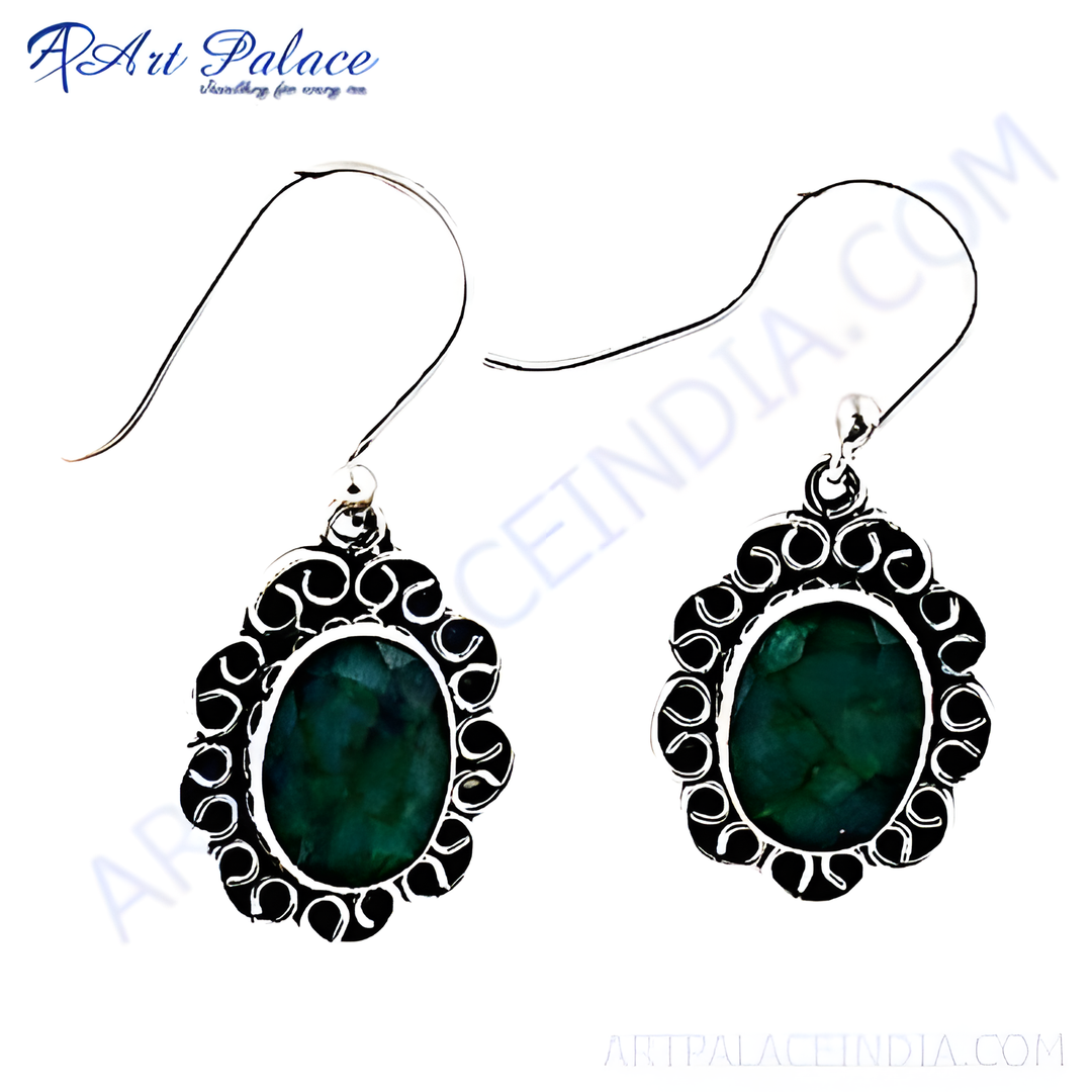 Sterling silver dangle earrings with oval emerald gemstones. Green stone in a detailed silver setting.