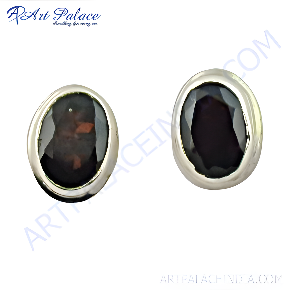 Close up of silver stud earrings with oval black gemstones set in a silver bezel