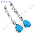 Load image into Gallery viewer, 925 sterling silver dangle earrings with pear-shaped turquoise stones and cubic zirconia accents.
